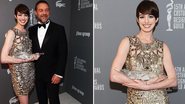 Eleita pelos designers de figurino, a atriz Anne Hathaway recebe prêmio Spotlight das mãos do ator Russell Crowe - Getty Images